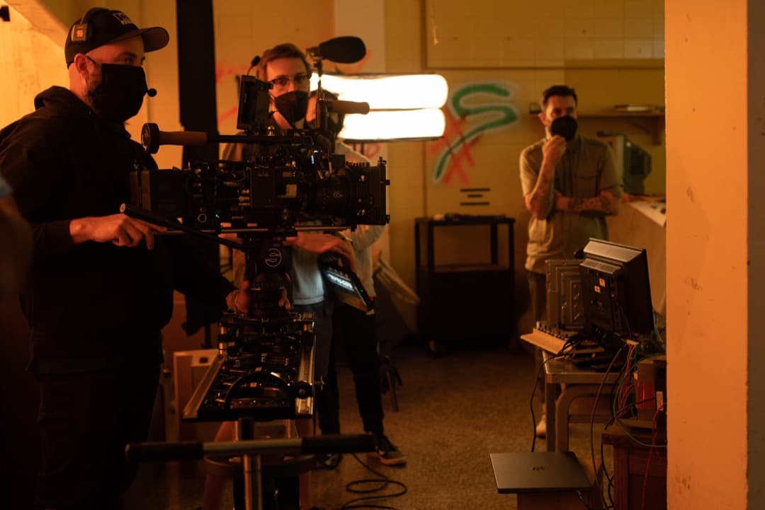 Behind the scenes photo 10 from Clone Cops production showing cinematographer corey allen, 2nd ac david king, and 1st ad nate eggert preparing for a scene